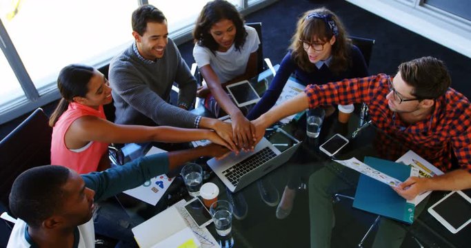 African American and mixed-race team of business people forming hand stack