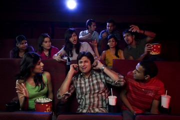 People staring at a man inside a cinema hall 