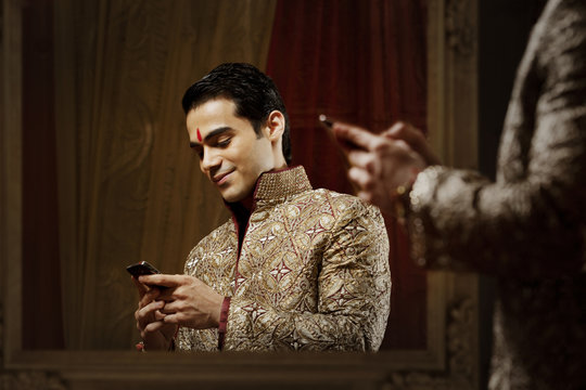 Groom reading an sms on a mobile phone 