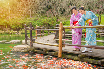 Japanese woman in front of water pond