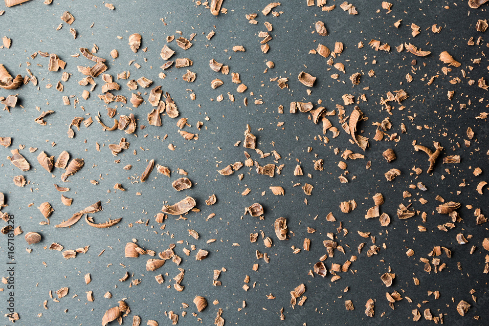 Poster chocolate crumbs on a black background with a gradient of light.