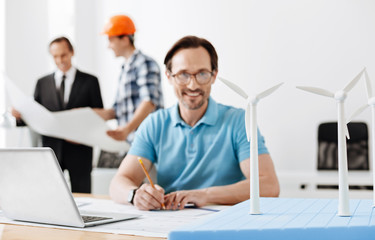 Young engineer developing blueprint of wind turbines