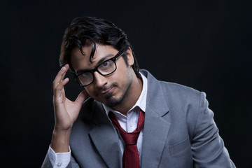 Portrait of irritated businessman over black background