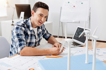 Young architect making changes in blueprint
