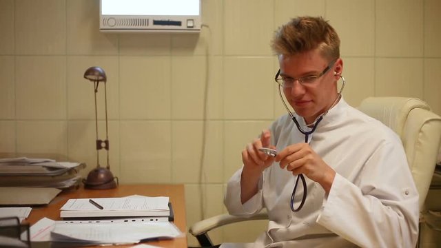 Doctor wearing stethoscope and having fun while looking to the camera
