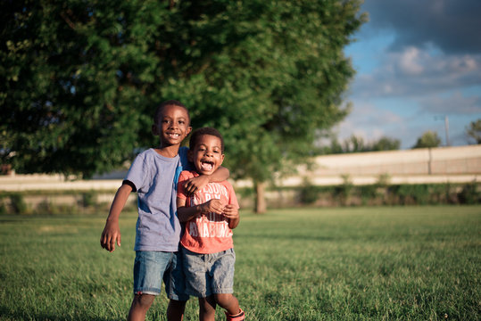 Cheerful brothers standing in the park