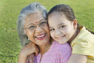 Portrait of grandmother and granddaughter smiling