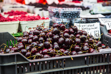 Cherries on the farm market in the city. Fruits and vegetables at a farmers market