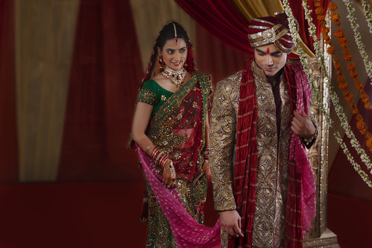 Bride looking at man during mangal phera 