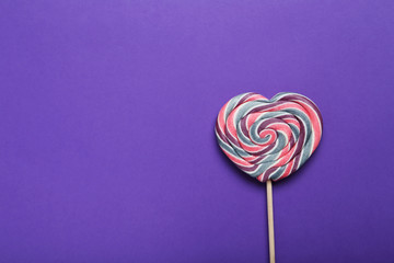 Sweet lollipop on purple background