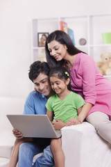 Family looking at laptop