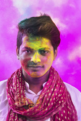 Portrait Of Young Man With Paint On Face During Holi