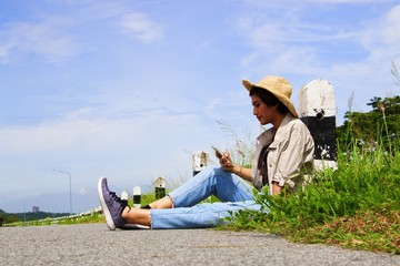 Woman is sitting at roadside