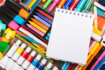Desk cluttered with office supplies