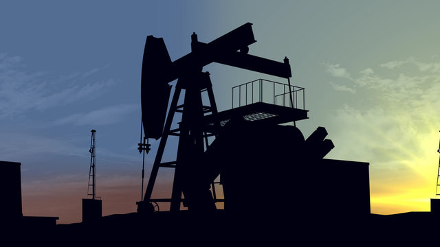 Oil pumps at sunset. Oil industry equipment.