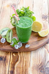fruit and vegetable green smoothie on a wooden table