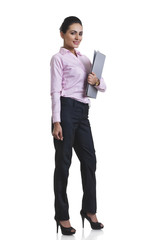 Full length portrait of Indian businesswoman holding file folder over white background