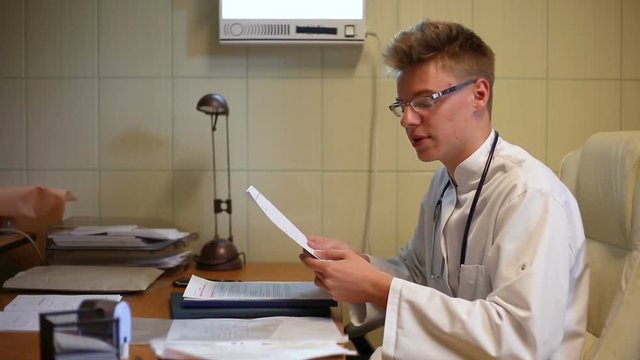 Doctor checking patient's results and looks worried
