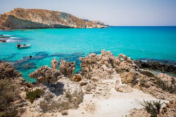 Fototapeta na wymiar Amazing view of Koufonisi island with magical turquoise waters, lagoons, tropical beaches of pure white sand and ancient ruins on Crete, Greece