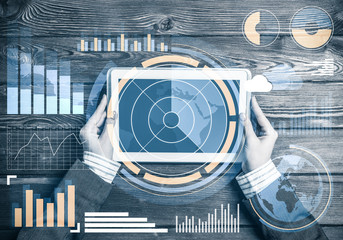 Business workplace with tablet device coffee cup and media graph