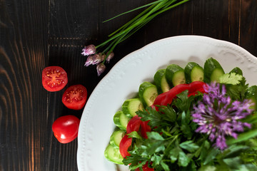 Fresh salad of tomatoes, cucumbers, peppers, arugula and dill jpg