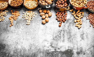 A lot of nuts in different bowls.