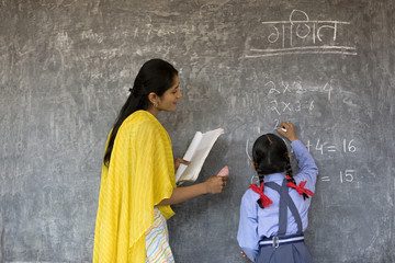 Young girl writing on the board 