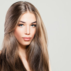 Naklejka premium Beautiful Woman with Long Brown Hair. Makeup, Hairstyle and Cute Face. Fashion Portrait