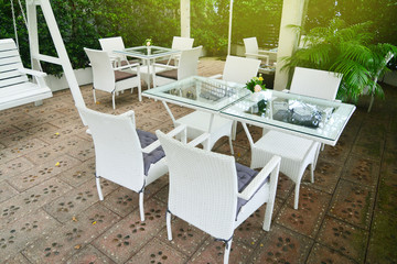 White chair and table in the green garden