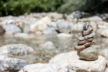 Fototapeta na wymiar balancing stones on the mountain river