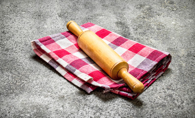 Serving background. Rolling pin on a napkin.