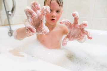 Fototapeta premium a child playing in a bubble bath at home