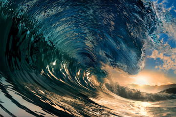 rough colored ocean wave falling down at sunset time - Powered by Adobe