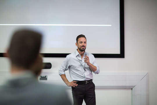 Businessman giving training to colleagues in conference room