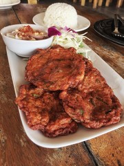 fish cake and spicy sauce with bowl of rice on the wooden floor, Thai food, spicy food, delicious of Thai food
