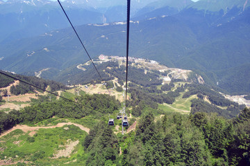 Summer landscape of Caucasian Mountains and cable car with funicular. Roza Khutor Alpine Ski Resort, Sochi, Russia