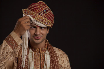 Gujarati groom with a headdress making a face 