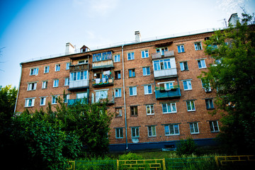 Brick house among green trees