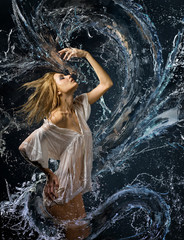 beautiful girl in a wet white shirt and a water dragon