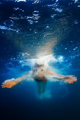 Fototapeta na wymiar professional female sport master smiling underwater