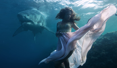 Great white shark approaching a drowning underwater model in pink dress