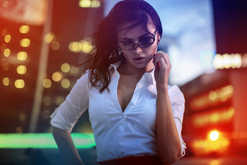 Brunette model in evening city lights