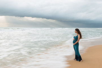 Fototapeta na wymiar Young beautiful pregnant woman standing