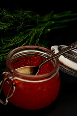 Fresh red caviar selective focus dark