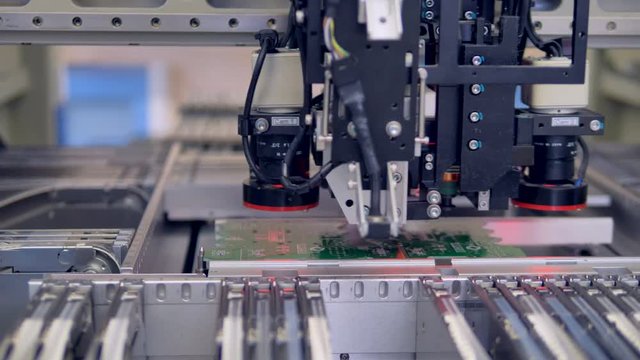 A SMT machine making a precise and accurate installation. Printed circuit board production.