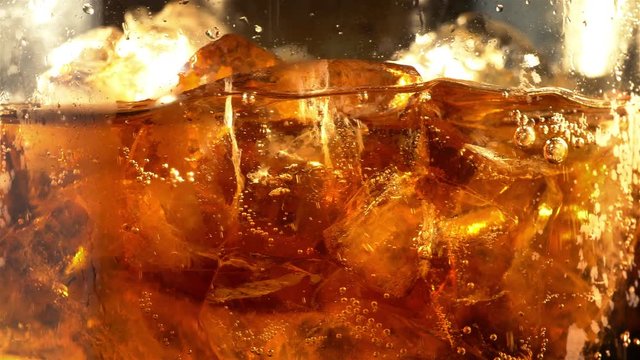 Video of cold cola with ice cubes in 4K