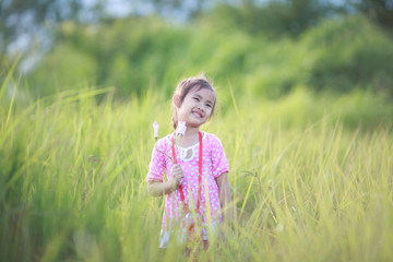 Stylish kid girl smiling in nature background