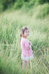 Stylish kid girl smiling in nature background