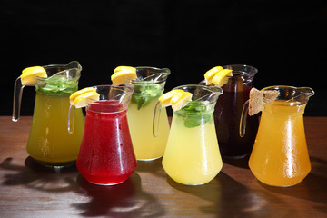 Cold compotes in large glass jars. Summer fruit drinks in glass jugs. Cold lemonades. Lemonade....