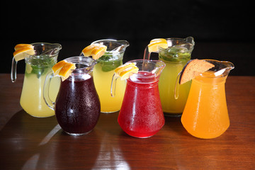 Cold compotes in large glass jars. Summer fruit drinks in glass jugs. Cold lemonades. Lemonade....